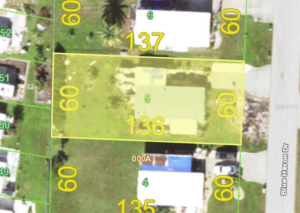 This is a map showing a rectangular property lot highlighted in yellow — 1574 BLUE HERON DRIVE, ENGLEWOOD, FL