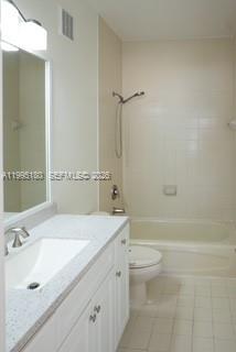 A bathroom features a white vanity with a sink, a toilet, and a shower-tub combination — 7070 NW 177th St # 10, Hialeah FL 33015, HIALEAH, FL