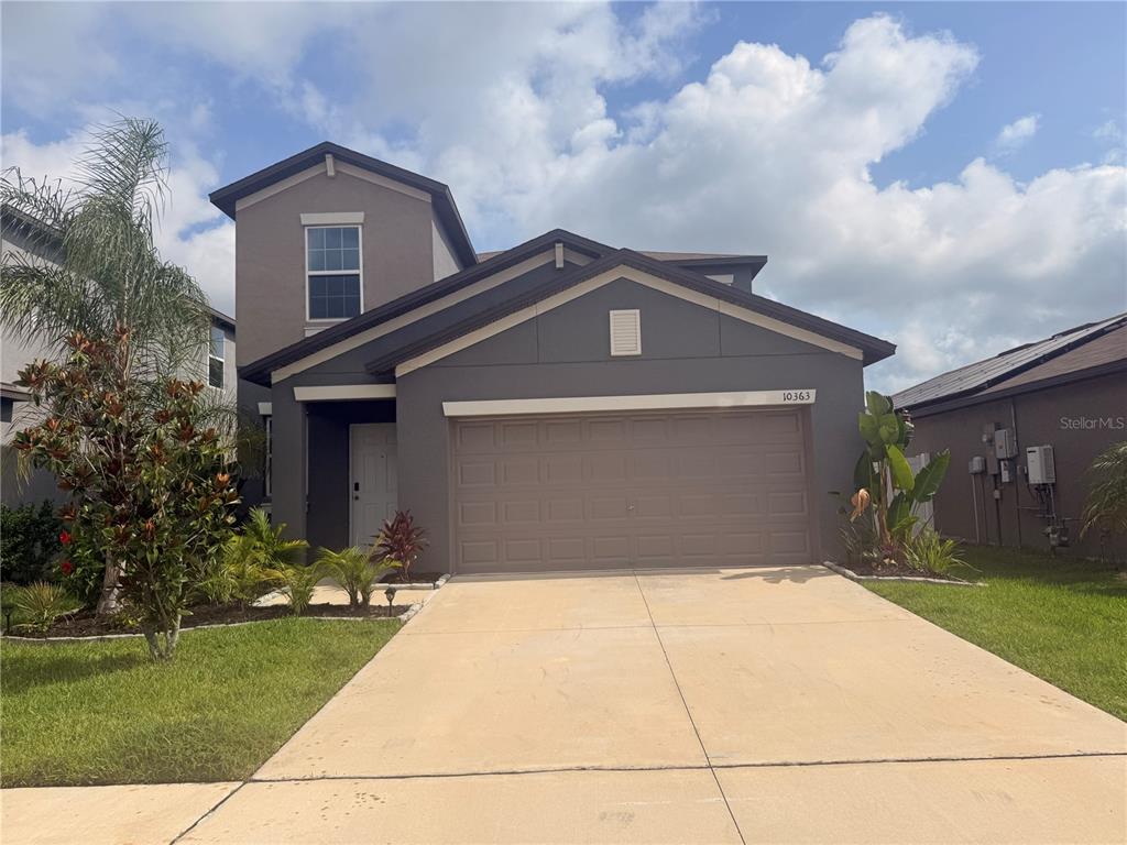 A two-story house with a gray exterior, a two-car garage, and a concrete driveway — 10363 SHADY PRESERVE DRIVE, RIVERVIEW, FL