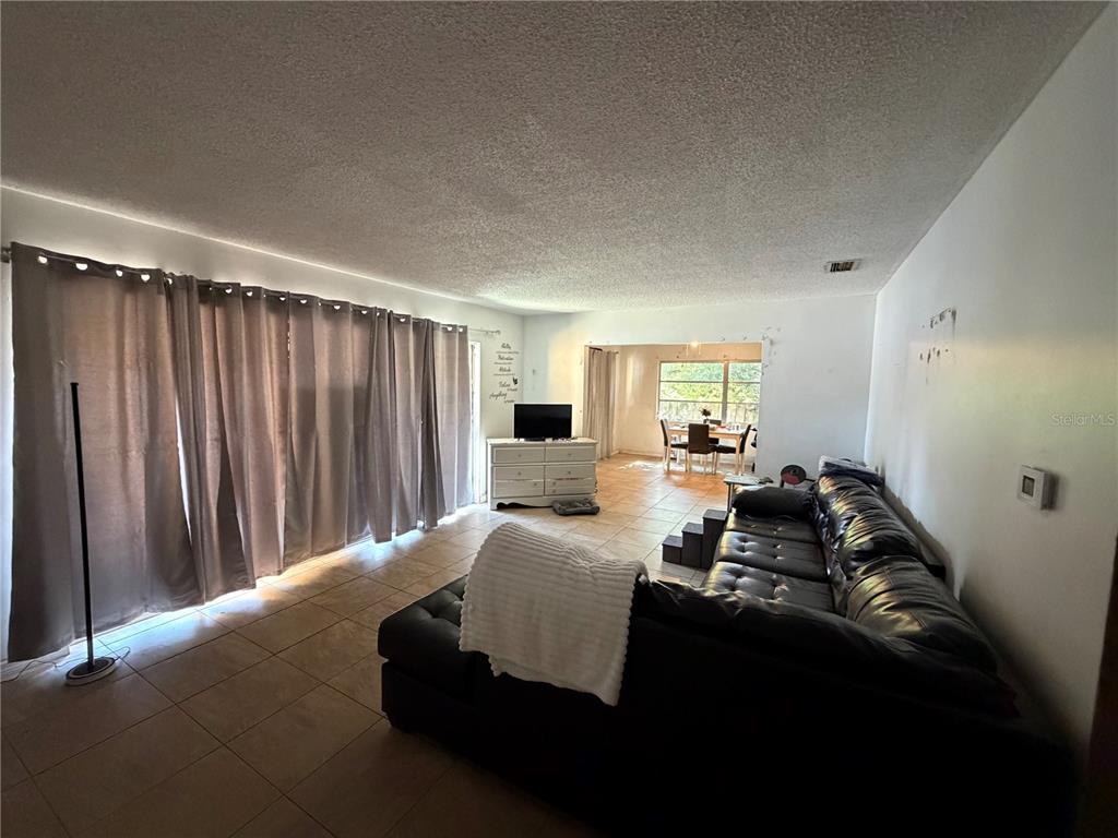 A tiled hallway leads through an arched doorway into a room with a wall shelf — 1330 EMILY COURT, CLEARWATER, FL