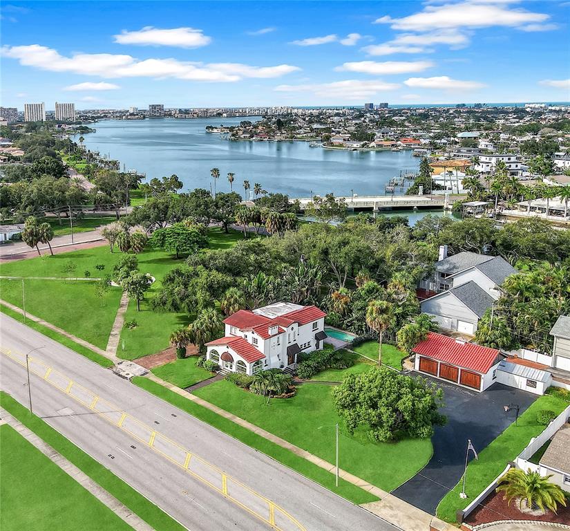 An aerial view shows a white house with a red roof, a detached garage, and lawn — 120 PARK STREET N, ST PETERSBURG, FL