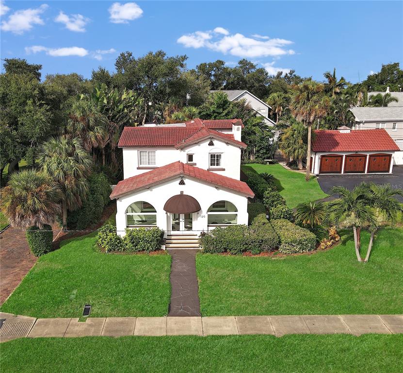 A two-story white house with a red tile roof and a detached three-car garage — 120 PARK STREET N, ST PETERSBURG, FL