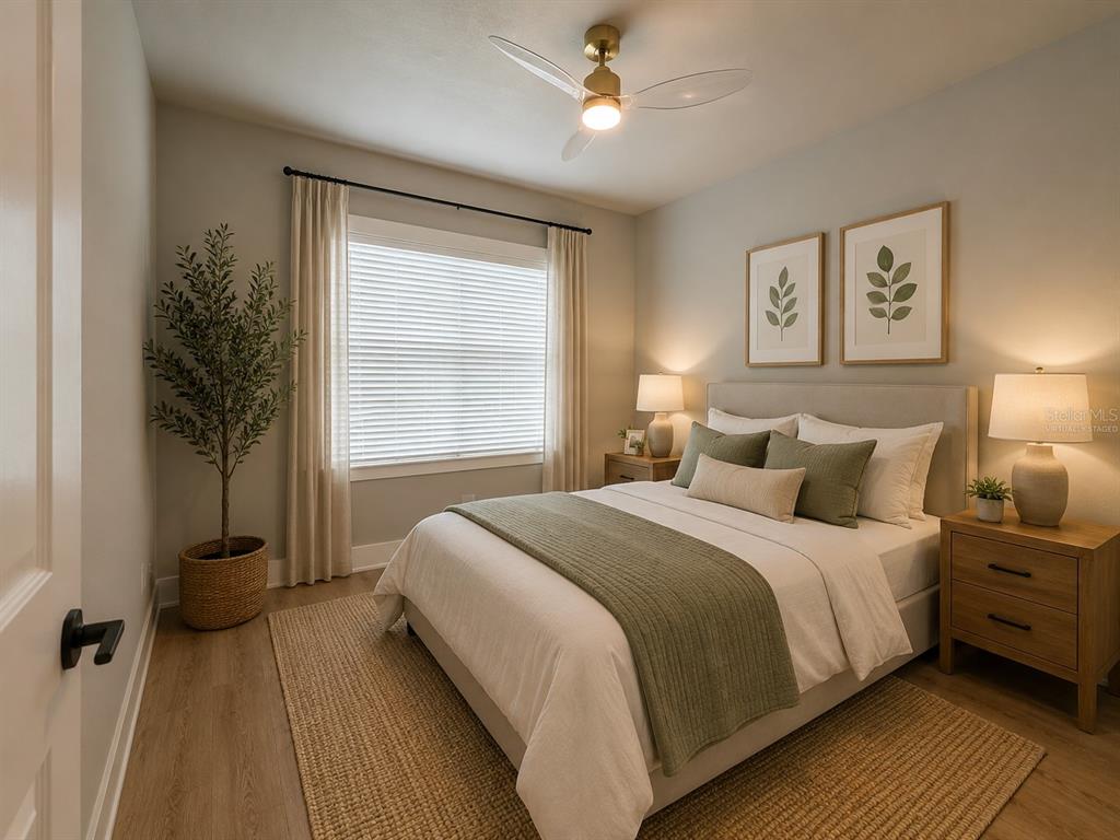 A bedroom features a queen bed, two nightstands, a ceiling fan, and a large window — 8308 GIBSON OAKS DRIVE, LAKELAND, FL