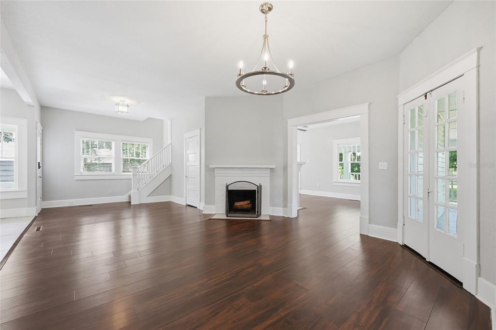 A living room features dark wood floors, a white fireplace, and French doors — 545 E HAINES BOULEVARD, LAKE ALFRED, FL