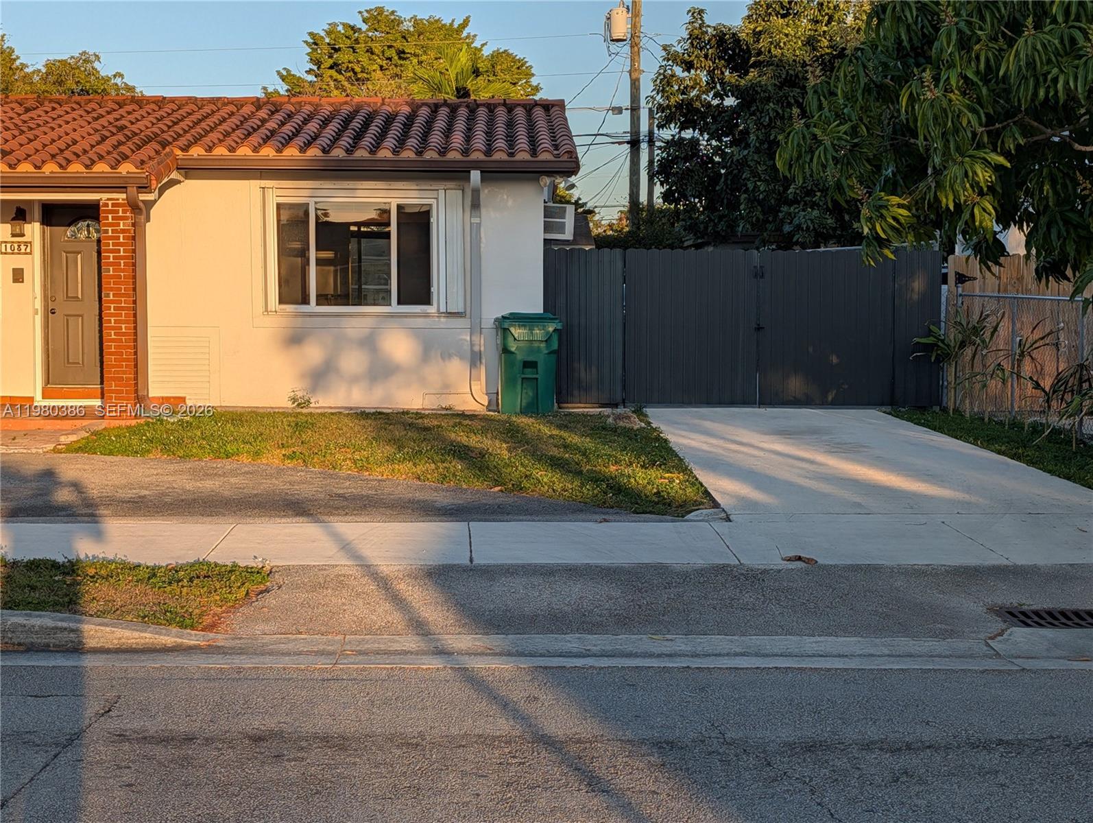 A single-story house with a tiled roof, a gray front door, and a concrete driveway — 1037 SW 76th Ave # 1037, Miami FL 33144, MIAMI, FL