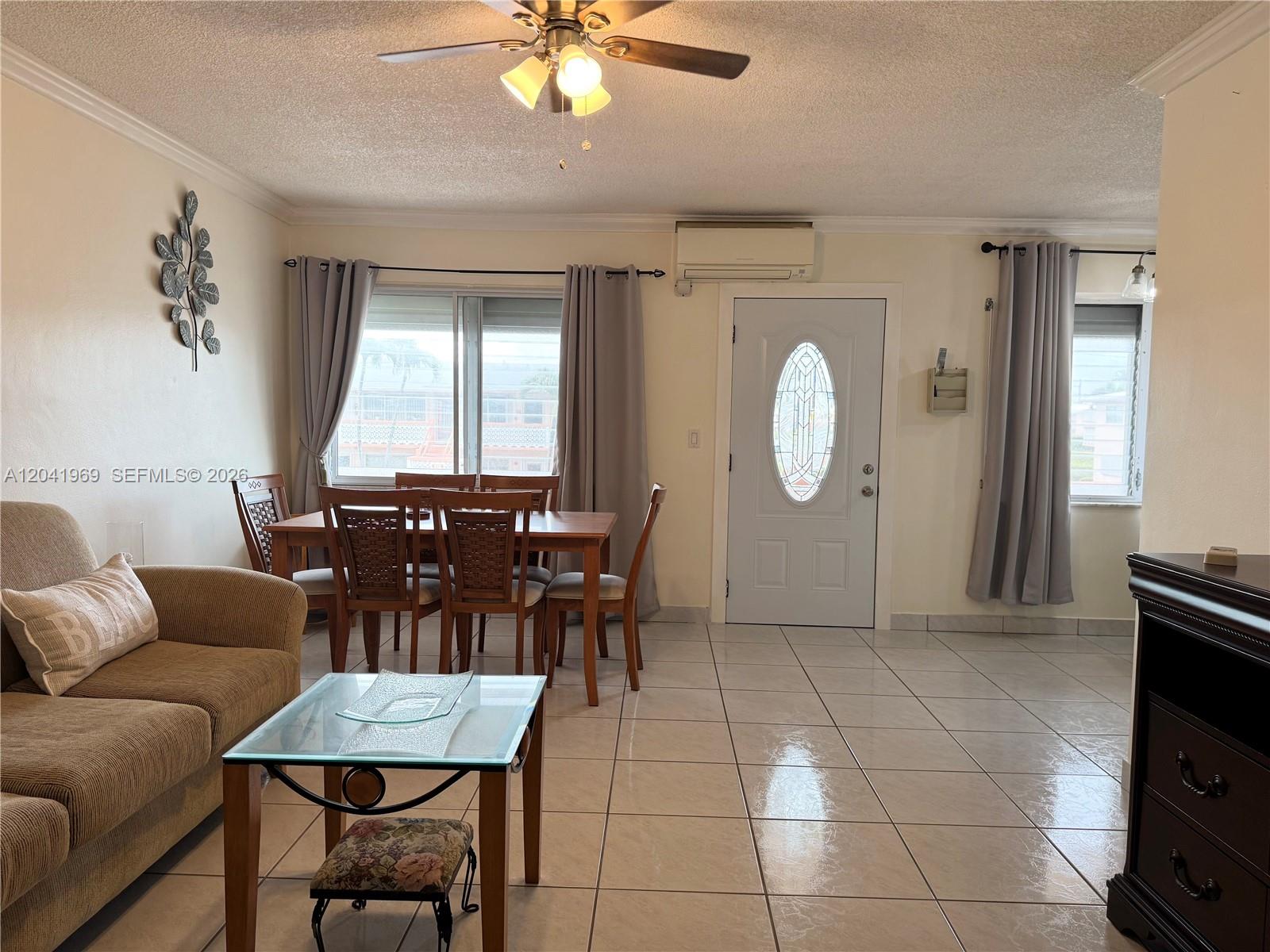 A living and dining area features tile floors, a ceiling fan, and a front door — 920 SW 11th Ave # 11, Hallandale Beach FL 33009, HALLANDALE BEACH, FL