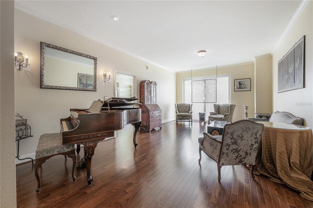 A spacious living room features a grand piano, hardwood floors, and traditional furniture — 700 S HARBOUR ISLAND BOULEVARD UNIT 716, TAMPA, FL