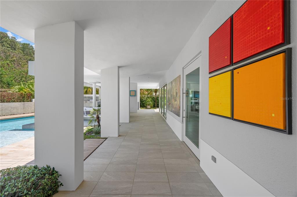 A spacious, high-ceilinged living and dining area with modern furniture, tile floors, and abstract art — 530 CAMINO DE GUILLARTE, DORADO, PR, PR