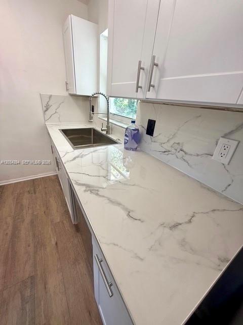 A kitchen features white cabinets, a marble-patterned countertop, and a stainless steel sink — 530 Mentone Rd, Lake Worth FL 33462, LAKE WORTH, FL