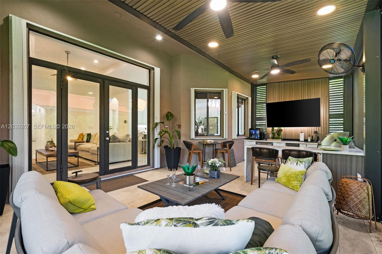 A covered outdoor patio features a sectional sofa, dining area, and a built-in bar — 7563 SW 188th Ter, Cutler Bay FL 33157, CUTLER BAY, FL