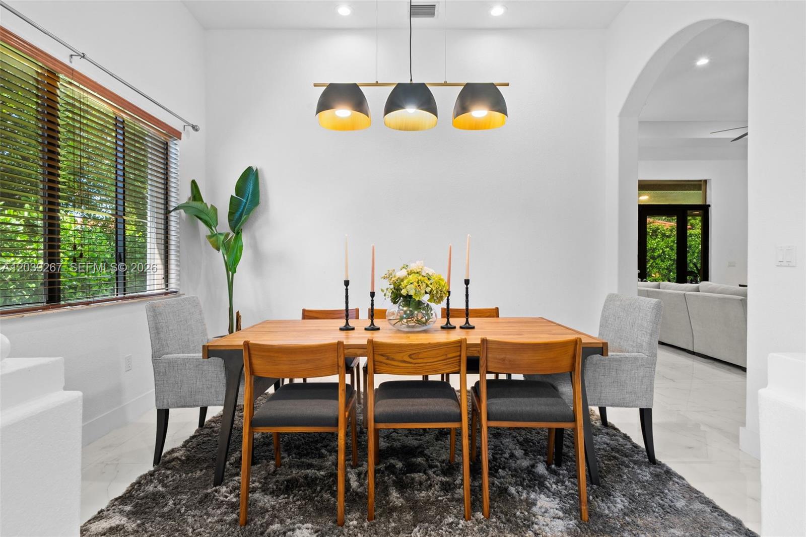 A dining room features a wooden table, six chairs, a pendant light, and a rug — 7563 SW 188th Ter, Cutler Bay FL 33157, CUTLER BAY, FL