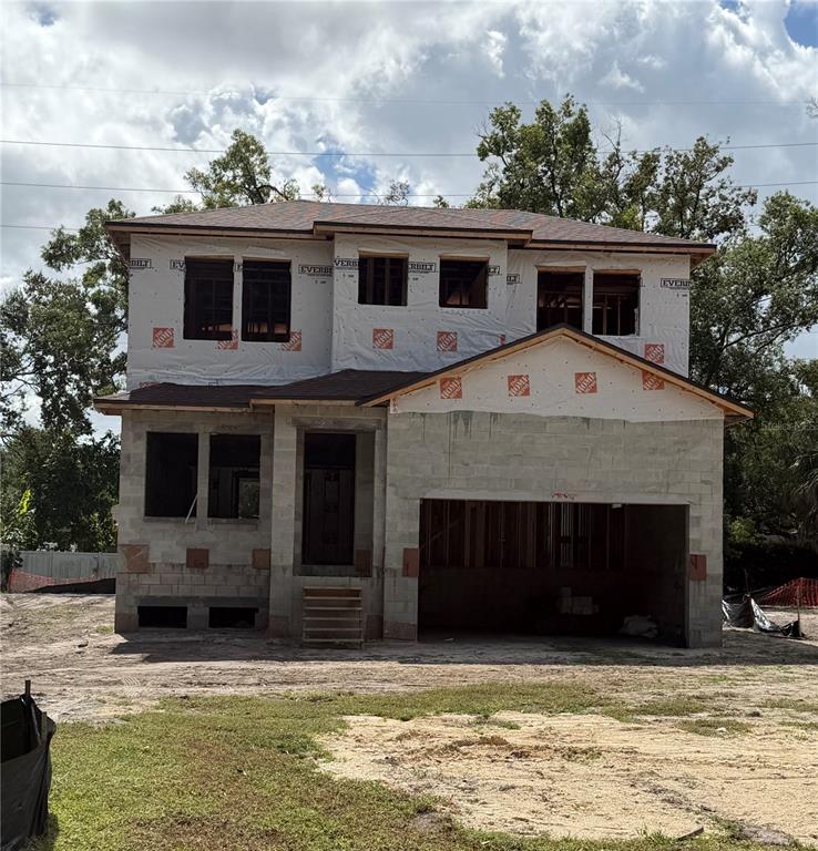 A two-story house under construction with concrete block walls and a partially installed roof — 2120 W BIRD ST., TAMPA, FL