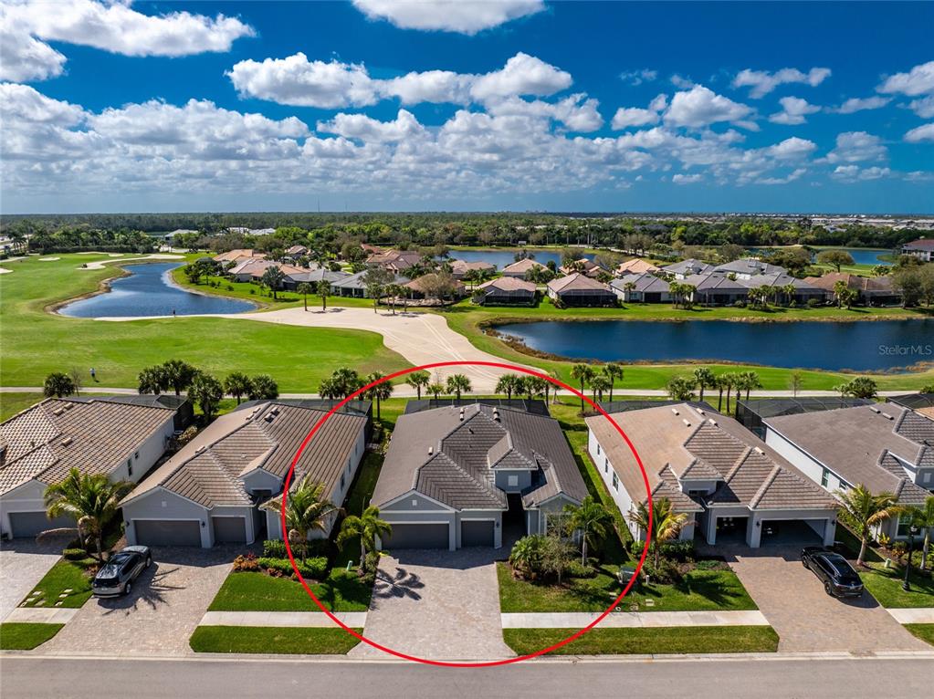 An aerial view shows a single-story house with a tiled roof and a paved driveway — 25223 KEYGRASS COURT, PUNTA GORDA, FL