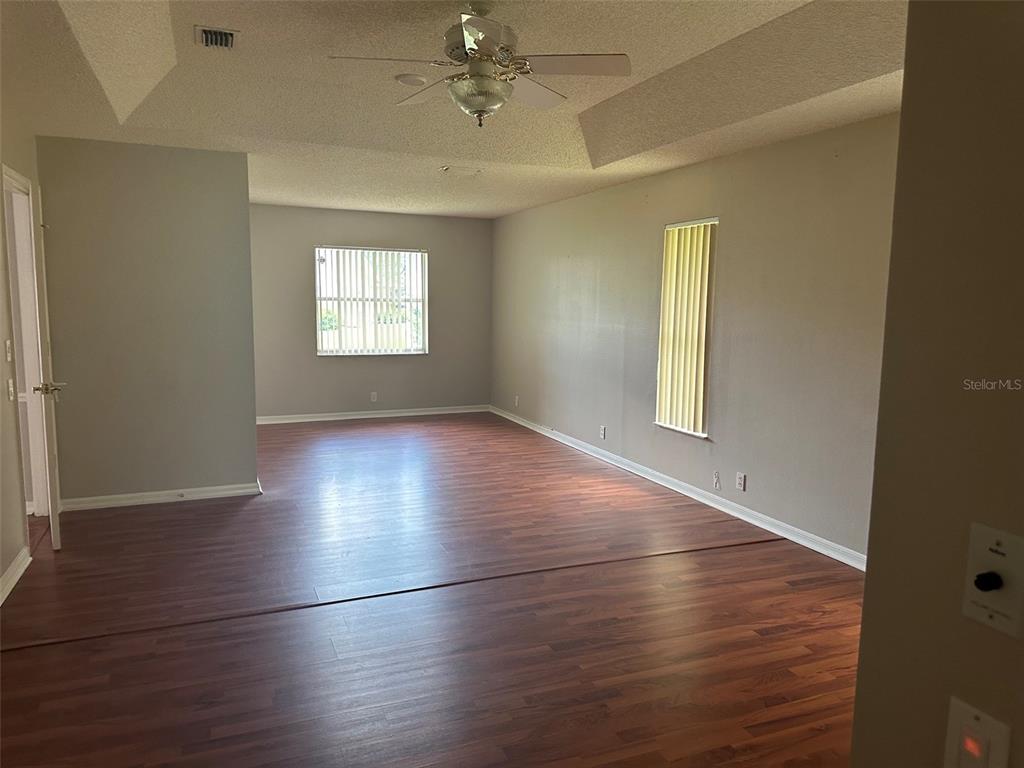 A single-story house with a white brick facade, arched windows, and a screened front entryway — 9685 SOUTHERN BELLE DRIVE, WEEKI WACHEE, FL