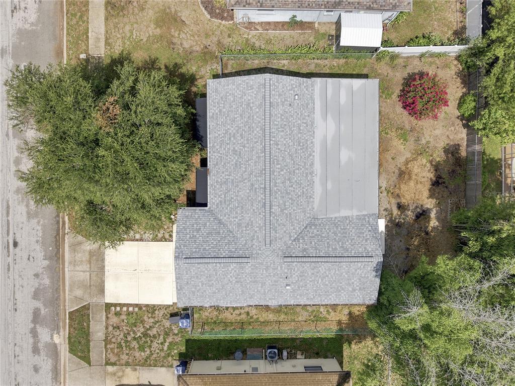 A single-story house with a white brick exterior, a front-loading garage, and a large tree — 7819 ROYAL STEWART DRIVE, NEW PORT RICHEY, FL