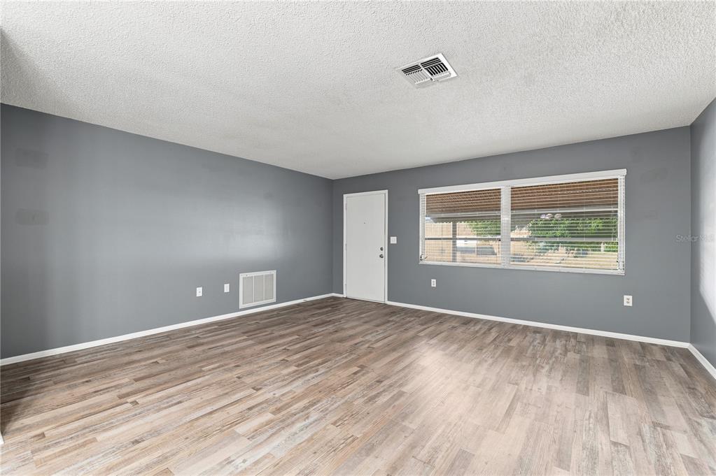 This is a floor plan of a house with a living room, kitchen, and bedrooms — 7819 ROYAL STEWART DRIVE, NEW PORT RICHEY, FL