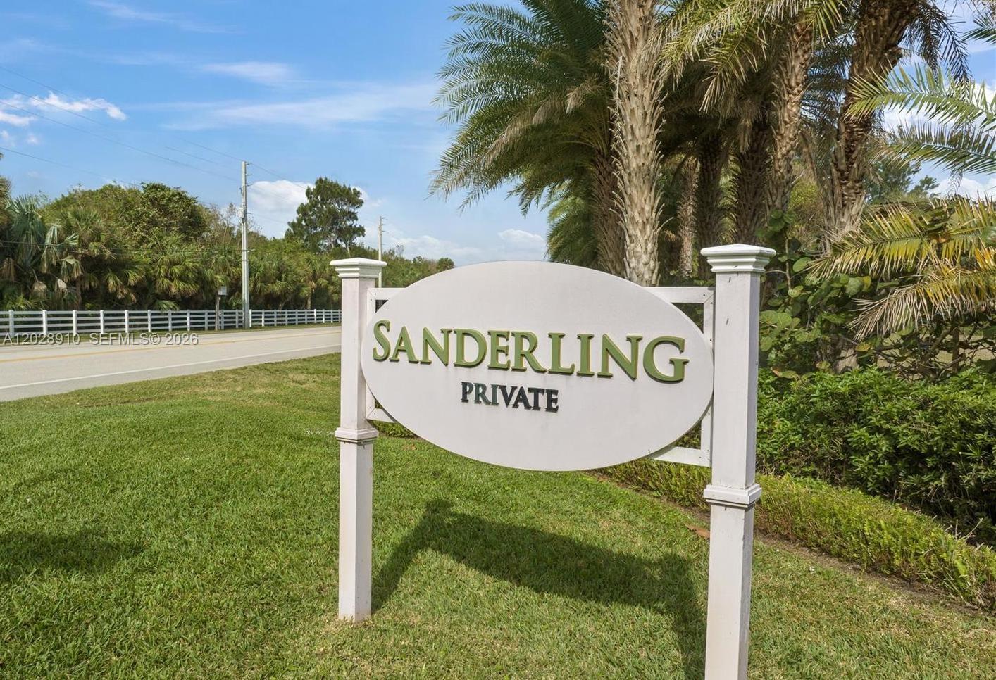 A white sign reading "Sanderling Private" stands on a grassy lawn near palm trees — 2335 Sanderling Ln, Vero Beach FL 32963, VERO BEACH, FL