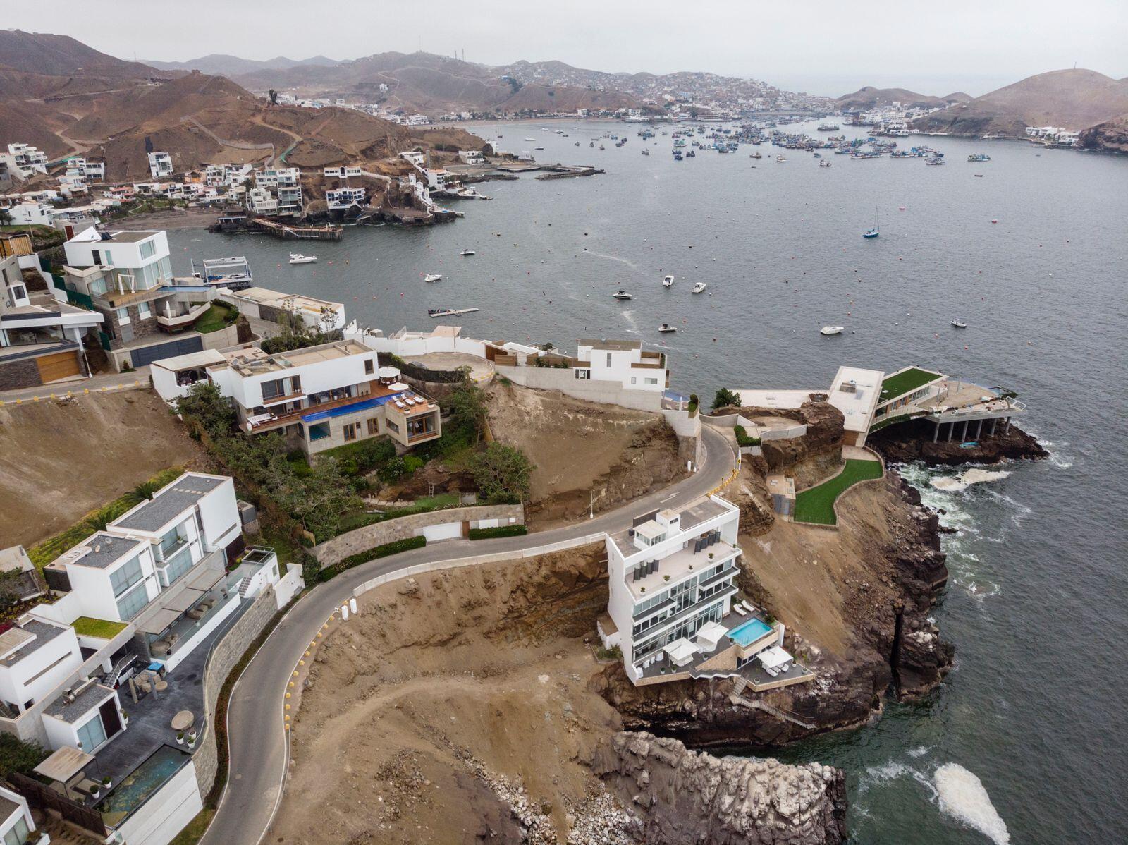 Aerial view of modern white cliffside houses overlooking a bay filled with many boats — 0600 Zona Sol Del Mar Mz.J Lt.5-6 # 0026, FL