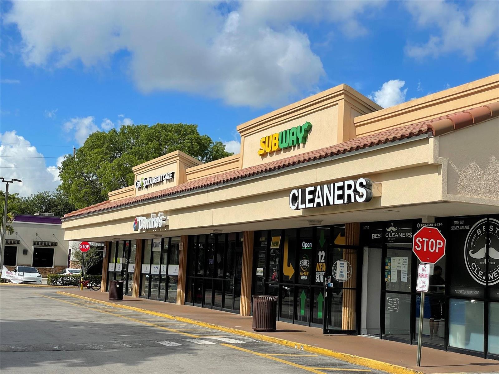 A strip mall exterior features a Subway, Domino's, and dry cleaner with a parking lot — 18606 NW 67th Avenue, Hialeah FL 33015, HIALEAH, FL