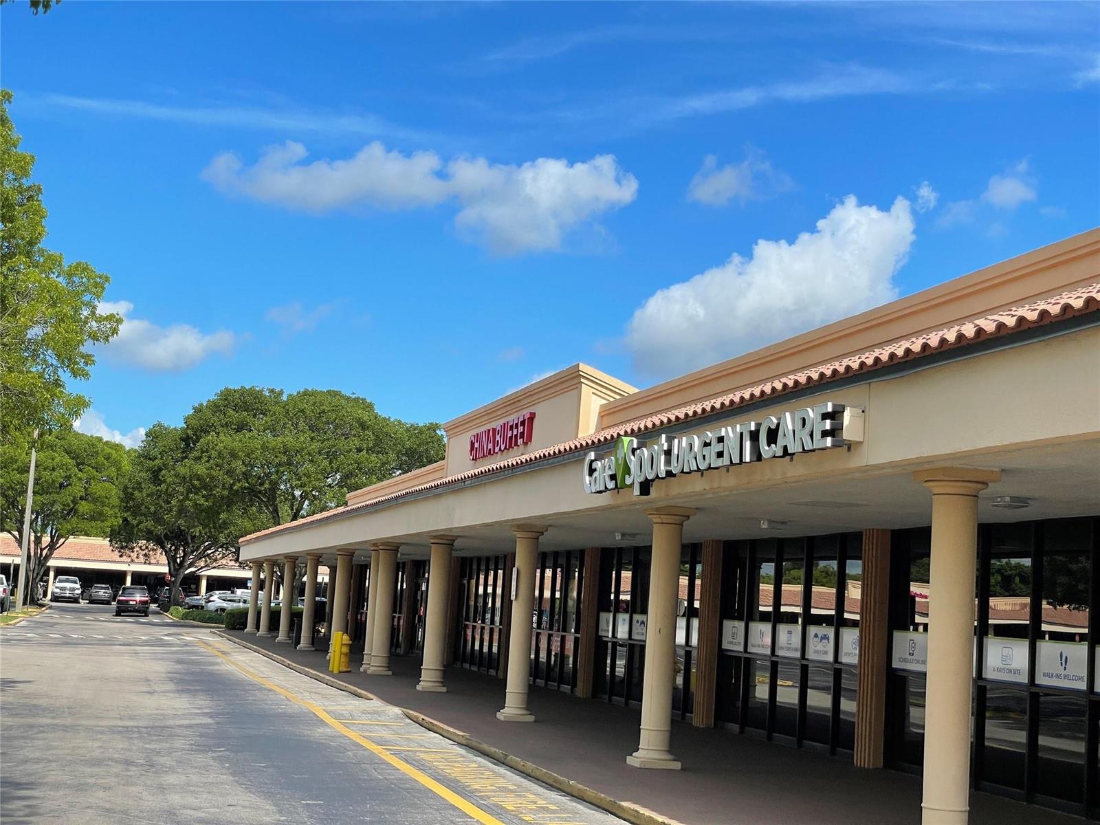 A strip mall exterior features a CareSpot Urgent Care, a China Buffet, and covered walkways — 18606 NW 67th Avenue, Hialeah FL 33015, HIALEAH, FL