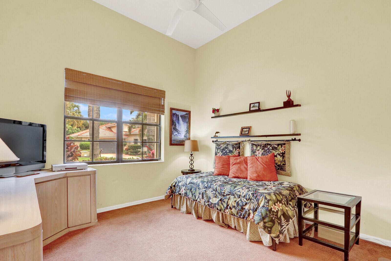 A bedroom features a daybed, a television console, a window with blinds, and carpeted flooring — 7159 Boscanni Drive, Boynton Beach FL 33437, BOYNTON BEACH, FL