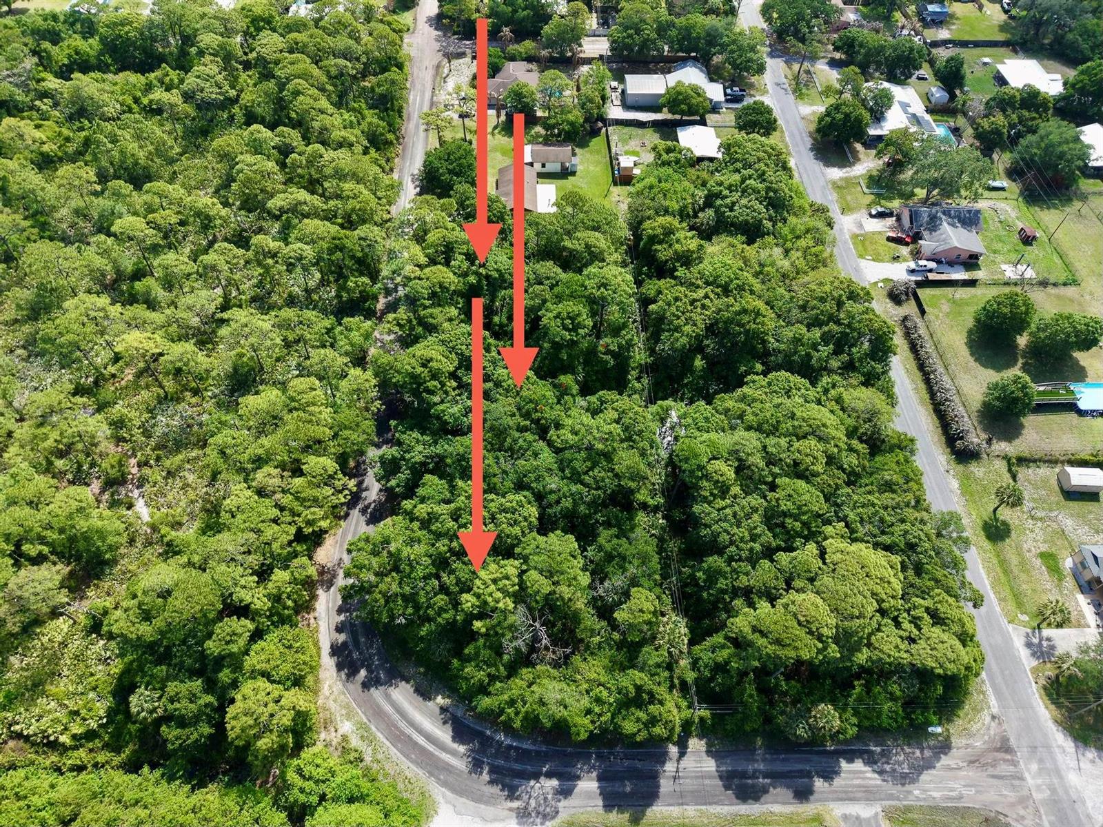 An aerial view shows a wooded lot with red arrows indicating the property boundaries — 0000 Notlem Drive, Fort Pierce FL 34982, FORT PIERCE, FL