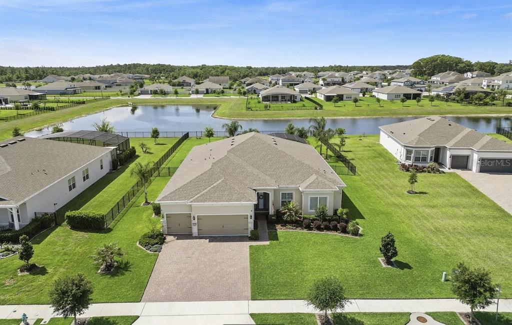 An aerial view shows a single-story suburban house with a tan roof and attached garage — 16118 BOWLINE STREET, ORLANDO, FL