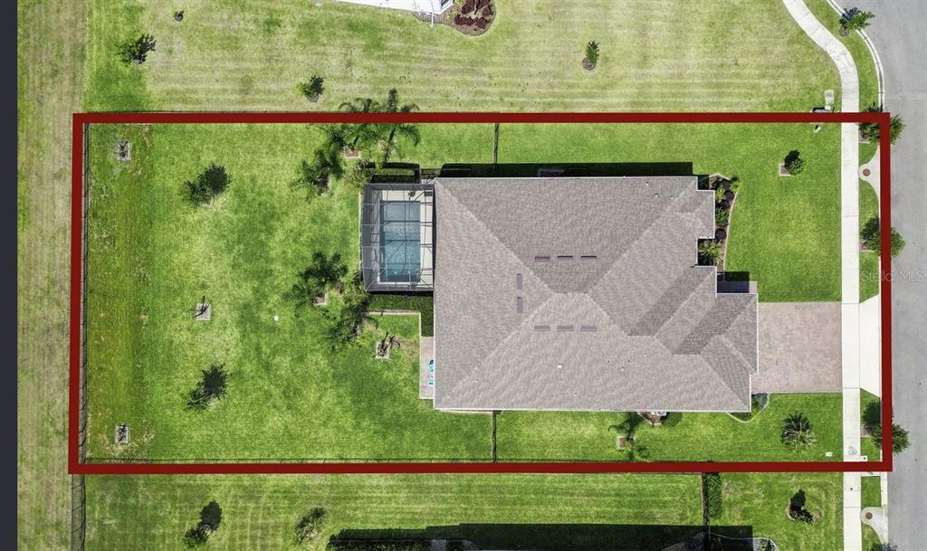 An aerial view shows a house with a screened pool on a large, fenced lot — 16118 BOWLINE STREET, ORLANDO, FL