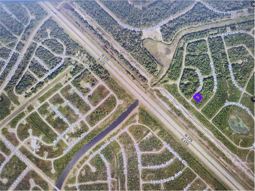 This is an aerial map showing residential streets and a highway in a wooded area — JUBILEE CIRCLE, NORTH PORT, FL