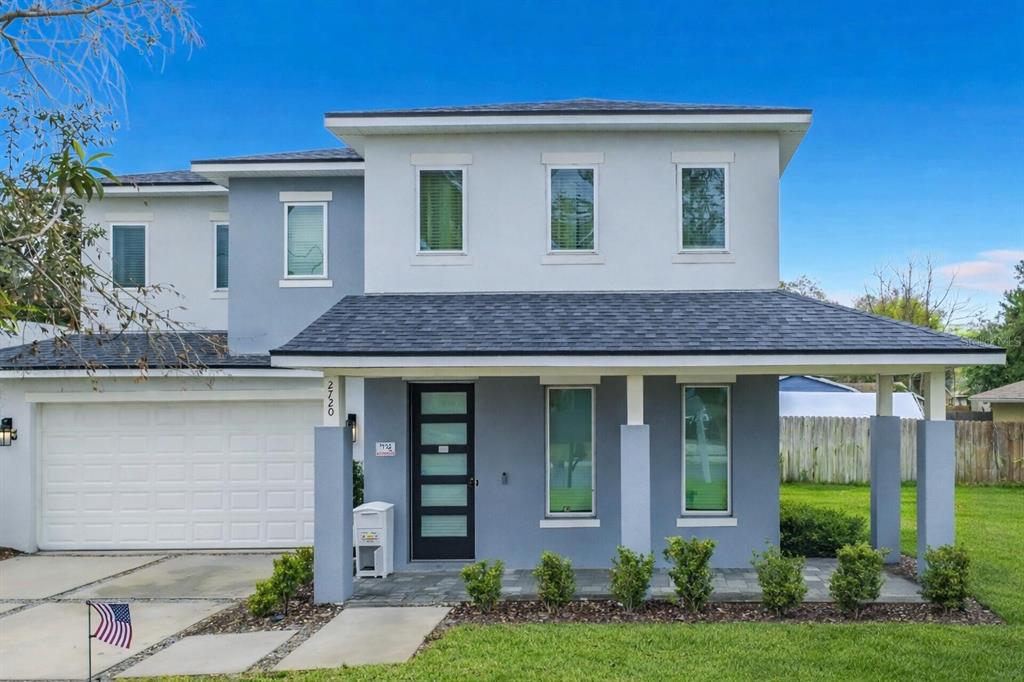 A two-story house with a gray exterior, a front porch, and an attached garage — 2720 S SHINE AVENUE, ORLANDO, FL