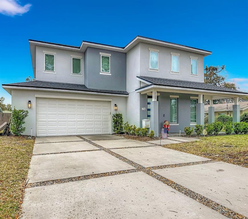 A two-story house with a gray and white exterior, a two-car garage, and a driveway — 2720 S SHINE AVENUE, ORLANDO, FL