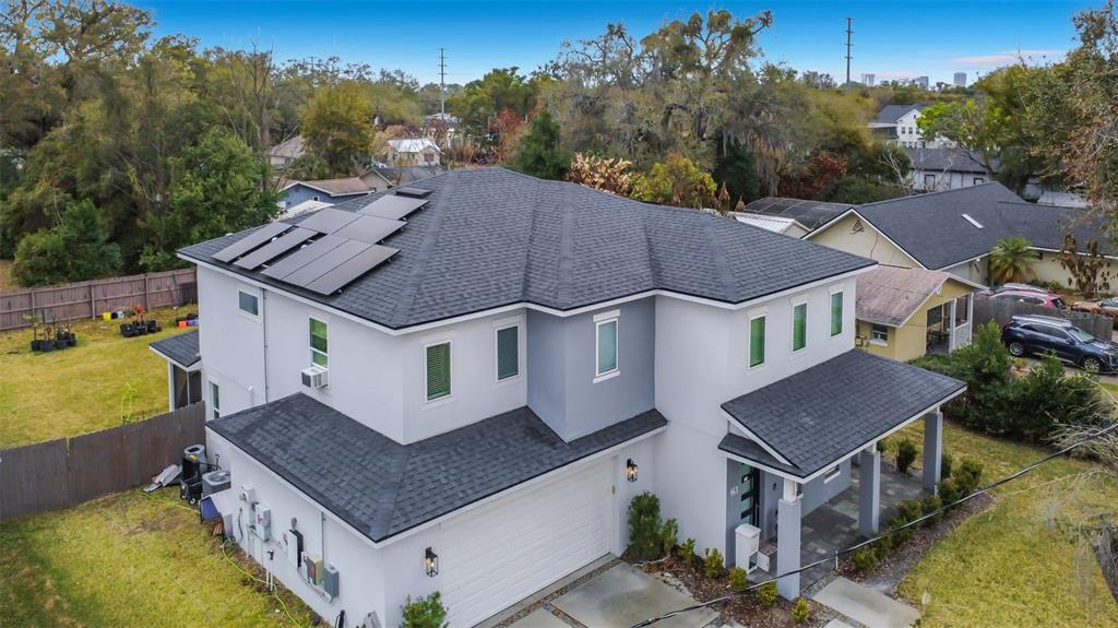 An aerial view of a two-story house with a shingled roof and solar panels — 2720 S SHINE AVENUE, ORLANDO, FL