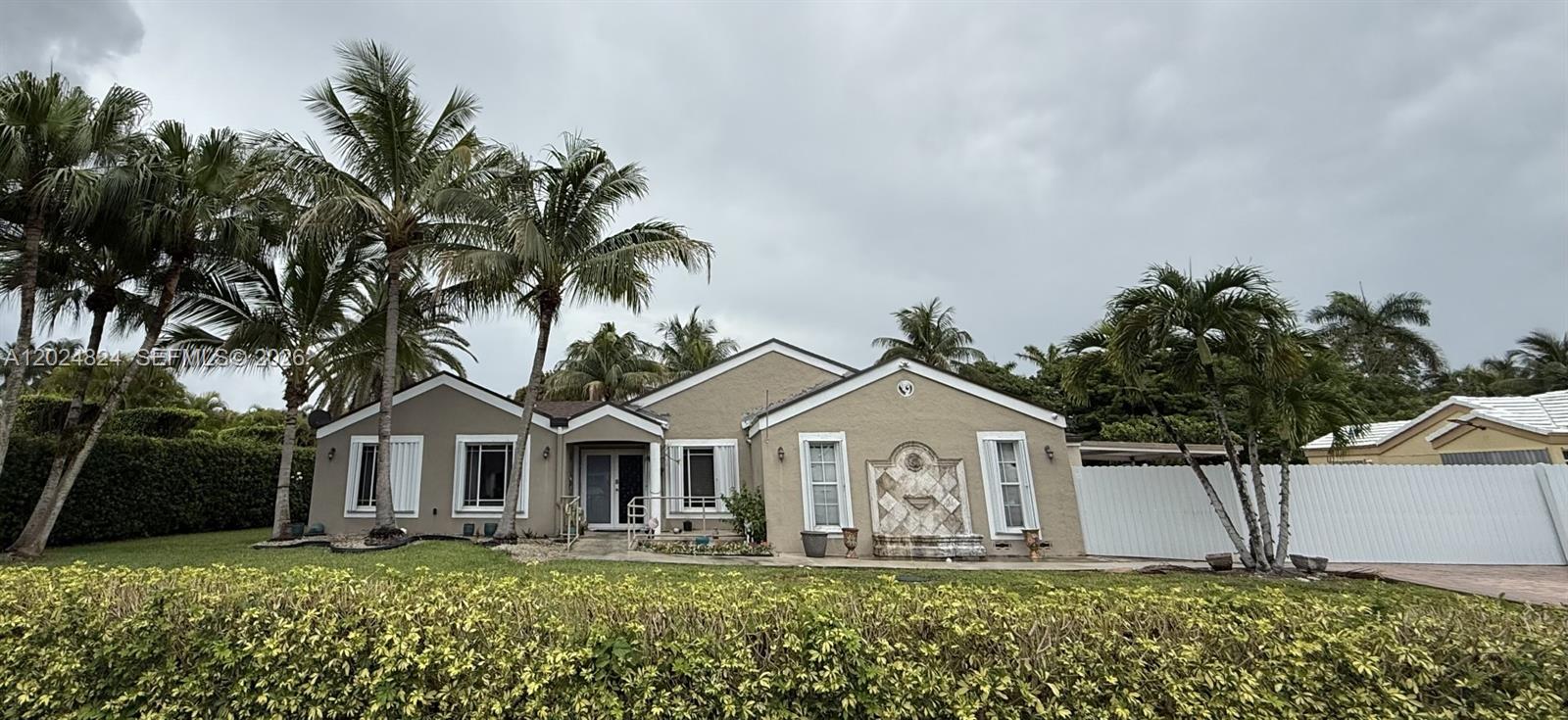A single-story house with a beige exterior, palm trees, and a front yard hedge — 15530 SW 155th Ave, Miami FL 33187, MIAMI, FL