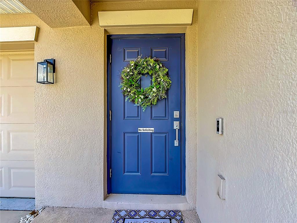 A blue front door with a wreath and a no soliciting sign on a porch — 237 TAFT DRIVE, DAVENPORT, FL
