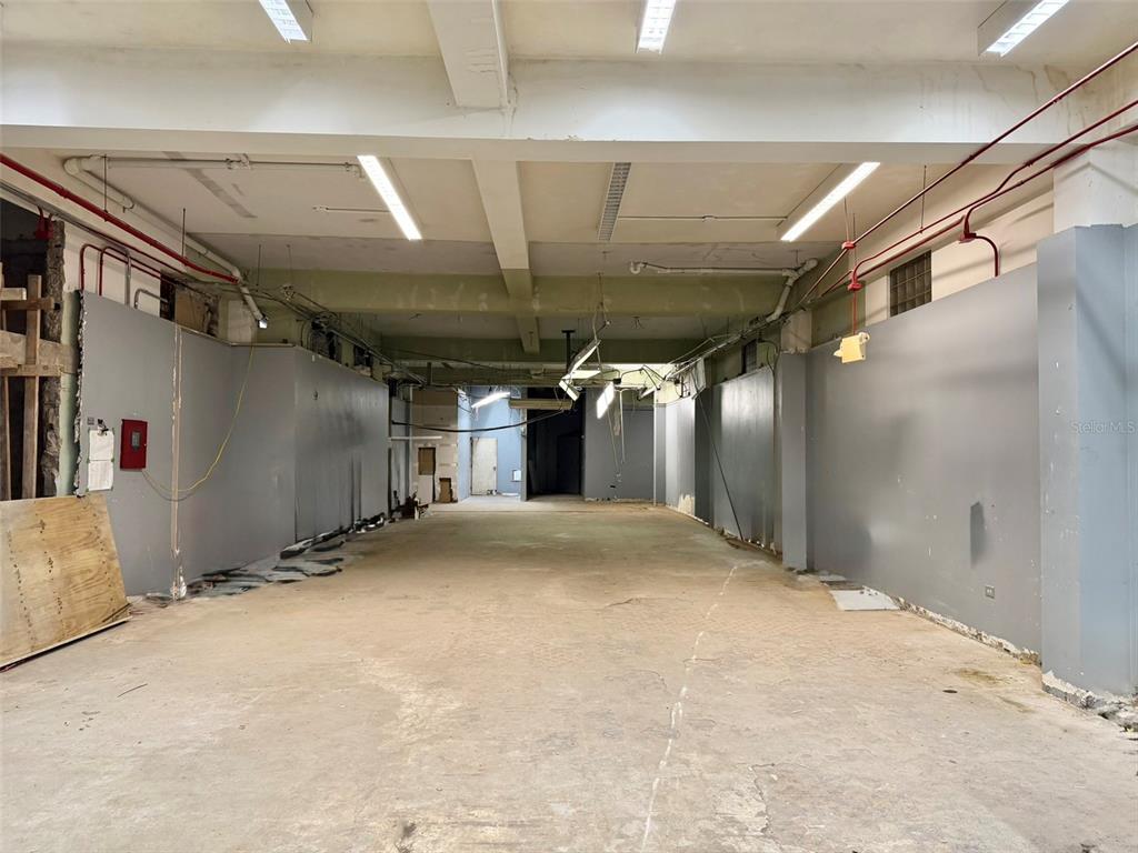 An unfinished, long commercial space features exposed ceilings, concrete floors, and gray painted walls — 1204 PONCE DE LEON AVENUE UNIT LOCAL B, SAN JUAN, PR
