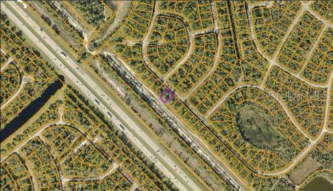 This is an aerial map showing a highlighted residential lot located near a highway — KIMBERLY DRIVE, NORTH PORT, FL