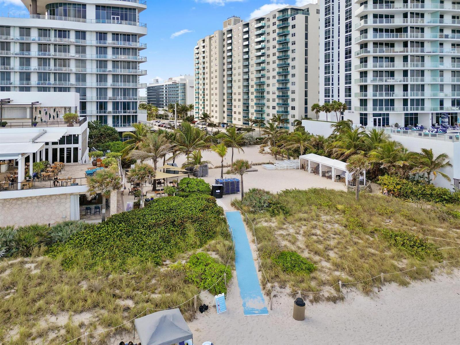 An aerial view shows a beach access path leading to a resort with tall buildings — 4001 S Ocean Drive # 14D, Hollywood FL 33019, HOLLYWOOD, FL