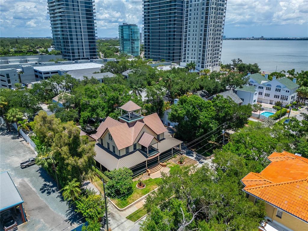 An aerial view shows a historic house with a cupola surrounded by trees and skyscrapers — 3007 W STOVALL STREET, TAMPA, FL