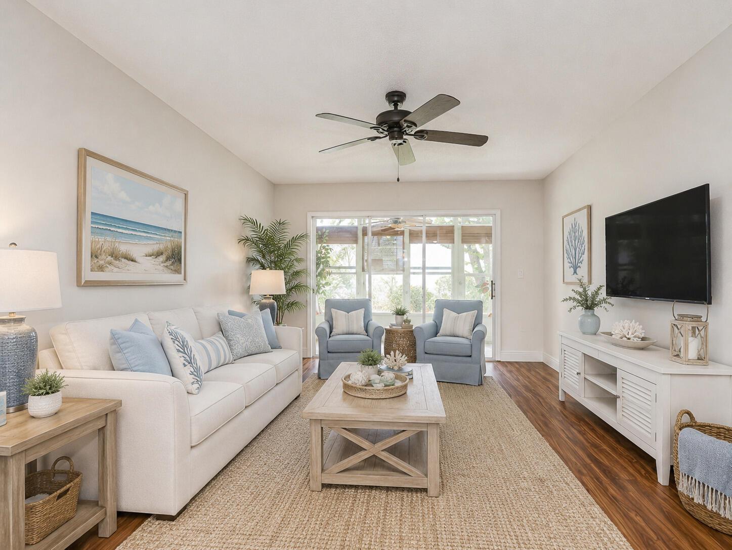 A coastal-style living room features a white sofa, two blue armchairs, and a wood coffee table — 2800 Indian River Boulevard # 4r, Vero Beach FL 32960, VERO BEACH, FL