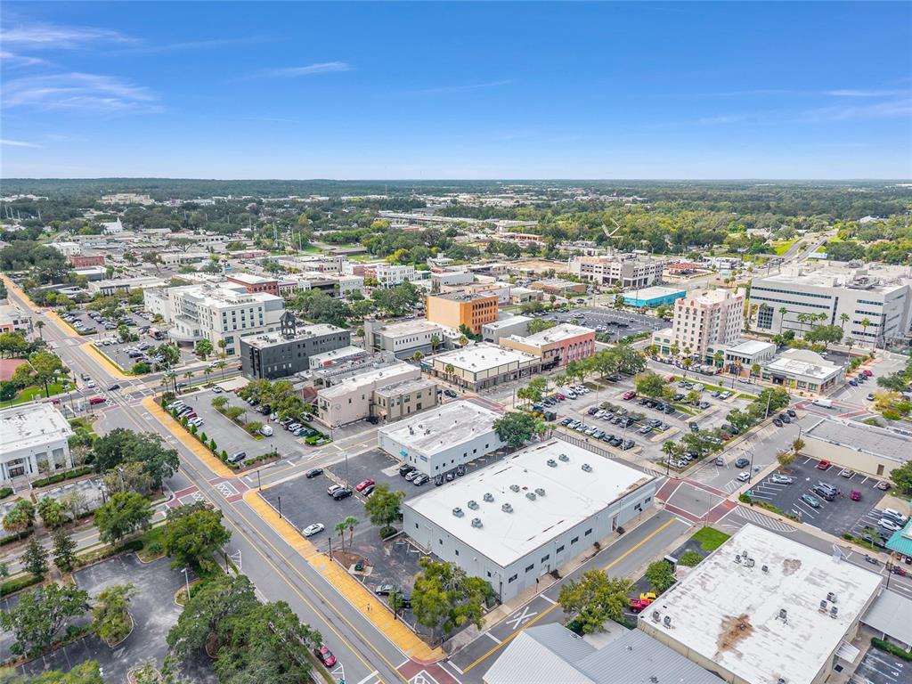 An aerial view shows a city downtown area with various commercial buildings, parking lots, and streets — 125 N 1ST AVENUE, OCALA, FL
