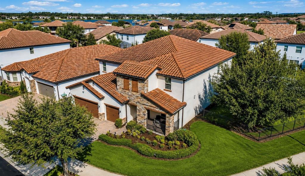 An aerial view of a two-story house with a tile roof and stone accents — 10902 CITRON OAKS DRIVE, ORLANDO, FL