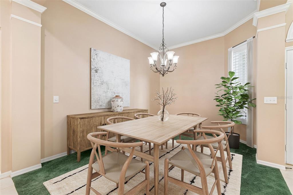A dining room features a wooden table, six chairs, a sideboard, and a chandelier — 12307 BRETON OAK LANE, RIVERVIEW, FL