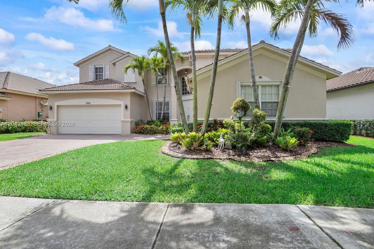 A two-story suburban house features a two-car garage, palm trees, and a landscaped front yard — 3904 W Gardenia Ave, Weston FL 33332, WESTON, FL