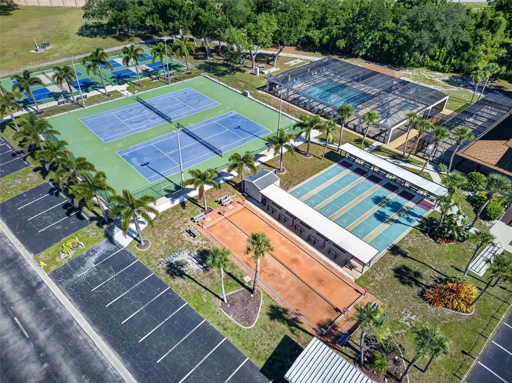 An aerial view shows tennis courts, shuffleboard courts, a bocce court, and a screened pool — 15550 BURNT STORE ROAD UNIT 237, PUNTA GORDA, FL