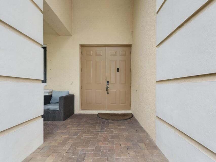 A tan double front door with a keypad lock sits on a brick patio — 846 Gazetta Way, West Palm Beach FL 33413, WEST PALM BEACH, FL