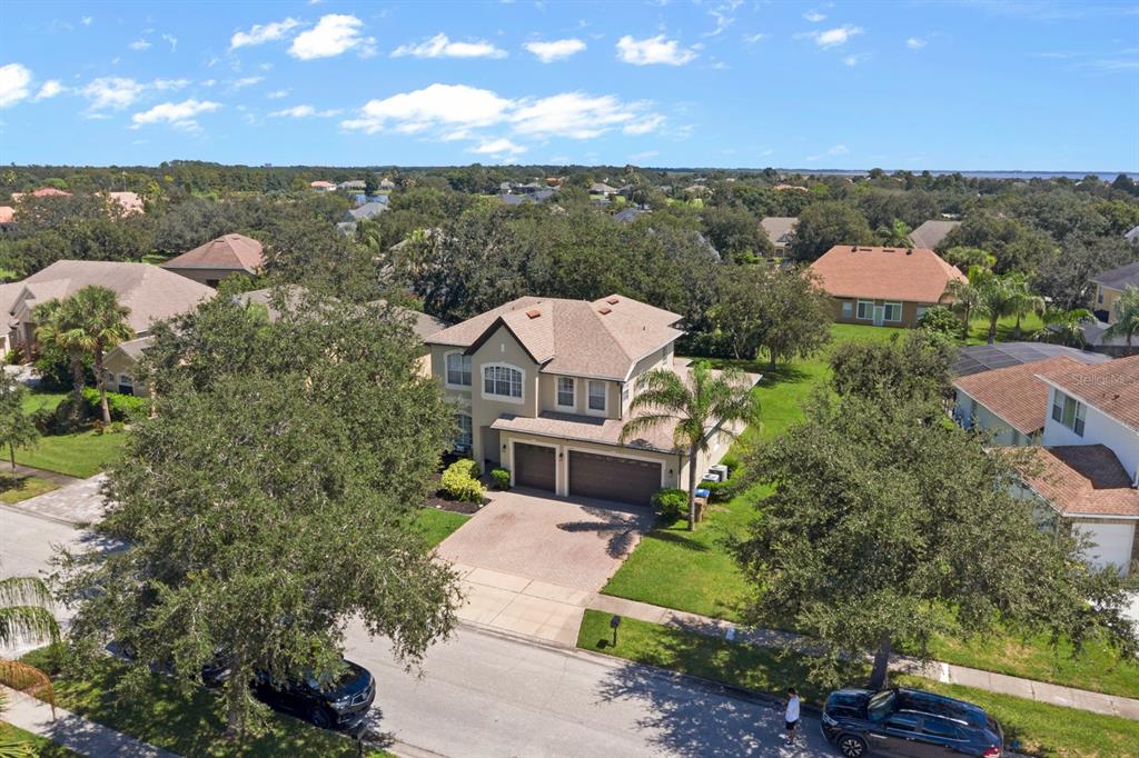 An aerial view of a two-story suburban house with a paved driveway and attached garage — 1705 BRIDGETS COURT, KISSIMMEE, FL