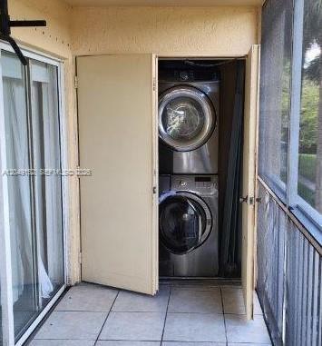 A stacked washer and dryer unit is housed in a closet on a screened-in balcony — 460 S PARK # 209, Hollywood FL 33021, HOLLYWOOD, FL
