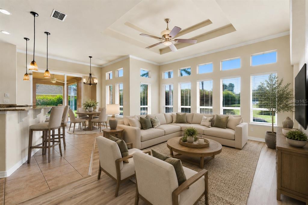 A game room features a pool table, a bar area with shelving, and sliding glass doors — 915 VISTA VERDE LANE, SUN CITY CENTER, FL