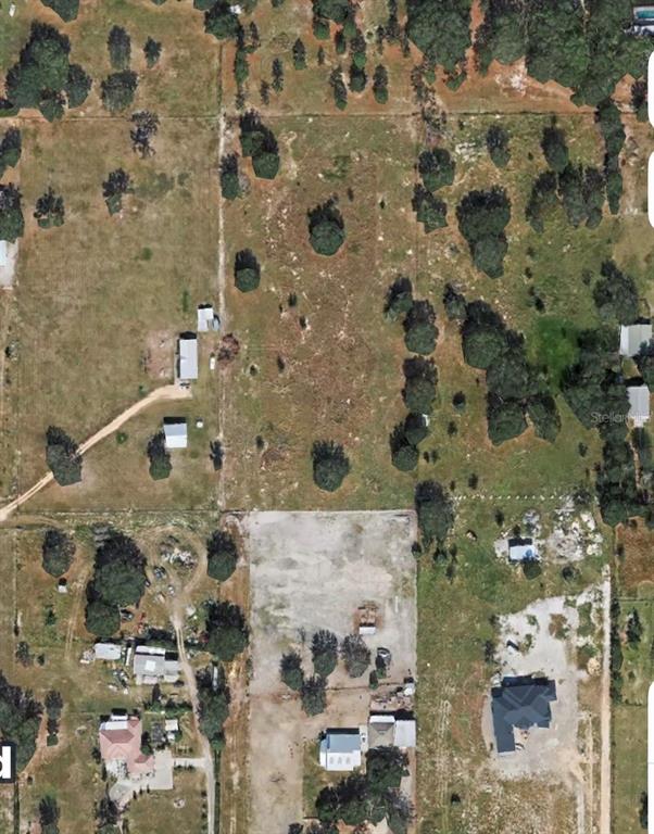 An aerial view shows several residential lots with houses, outbuildings, and scattered trees — LIBBY NO 3 ROAD, GROVELAND, FL