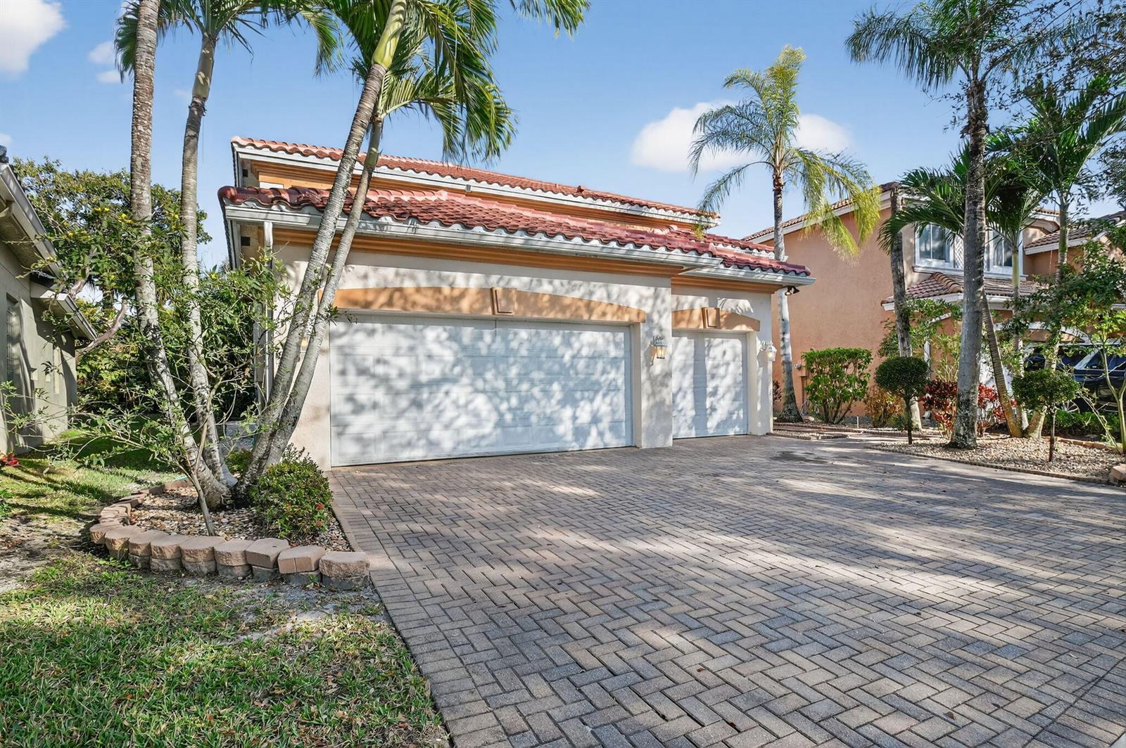 A beige house with a red tile roof and a brick paver driveway — 876 Gazetta Way, West Palm Beach FL 33413, WEST PALM BEACH, FL